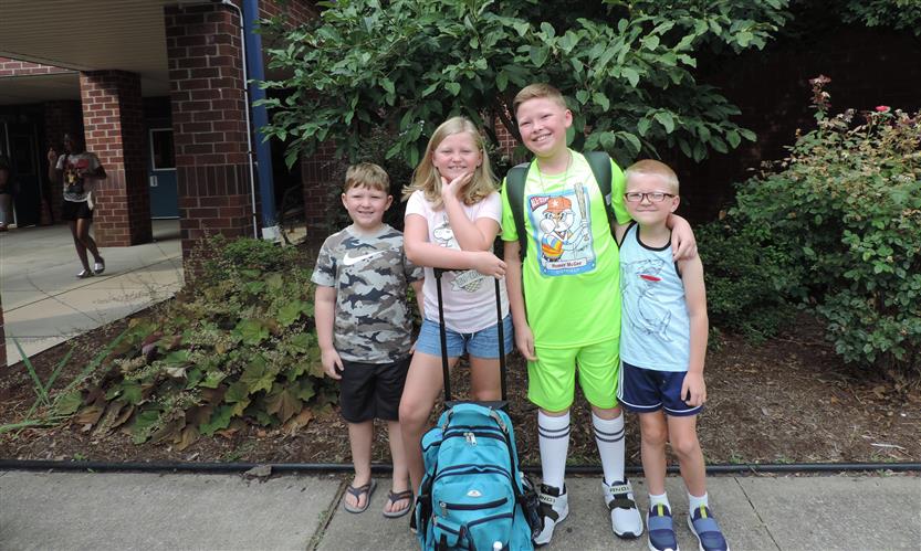 A group of students smiles
